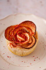 Fototapeta premium Apple rose puff pastry desserts on elegant plate with candle and flowers cozy romantic bakery concept