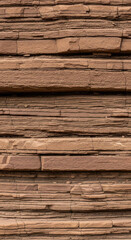 Obraz premium Detailed close-up of layered sandstone rock formation with natural texture and color variations