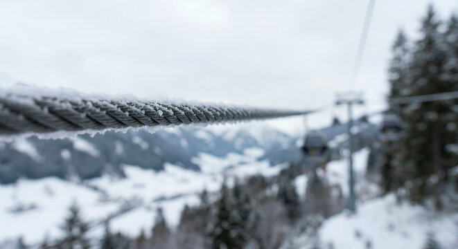 Snowy landscape with cable car and frosty trees in winter  