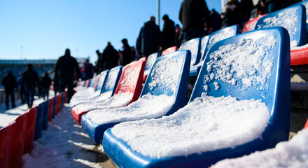 Empty stadium seats covered in snow on a sunny winter day  