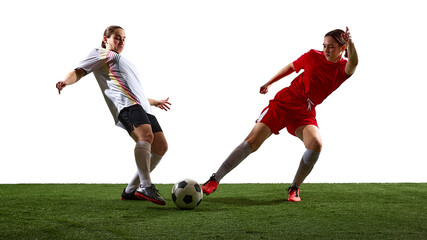 Naklejka premium Women soccer players competing for ball on white background. Concept of competitive play, defensive challenge, ball control, athletic movement, and professional football training situations.