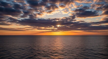 Obraz premium Vibrant Sunset Over Calm Ocean Water with Cloudy Sky