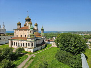 Church with a green roof and a white building. The church is surrounded by trees. Goritsky Assumption Monastery. Abolished in 1744, a male Orthodox monastery in the city of Pereslavl-Zalessky