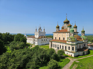 Church with a green roof and a white building. The church is surrounded by trees. Goritsky Assumption Monastery. Abolished in 1744, a male Orthodox monastery in the city of Pereslavl-Zalessky