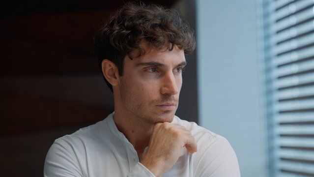 Portrait thinking Caucasian business man looking in window think contemplate puzzled hesitate businessman male guy dream executive specialist professional consider idea contemplating in company office