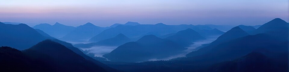 Obraz premium Serene Blue Mountain Landscape With Misty Valley Scene