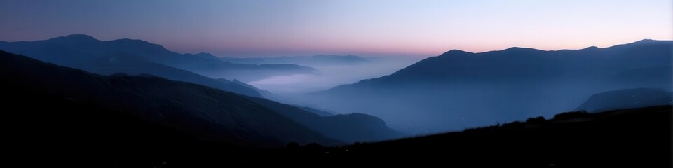 Serene Mountain Sunset Scene with Misty Valley and Blue Hues
