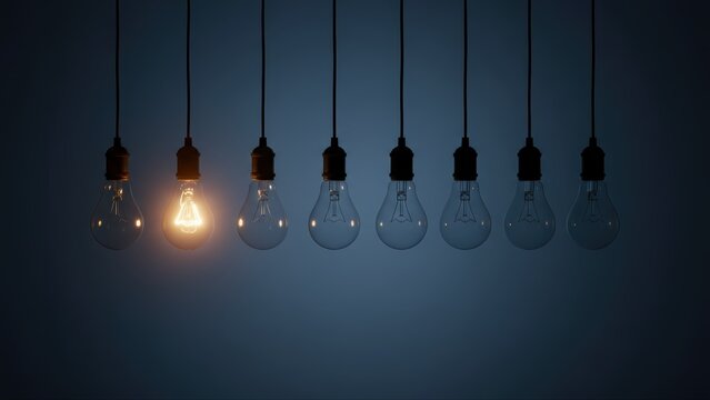 One glowing lightbulb uses electricity to stand out as a bright idea, innovation, and the final creative answer.