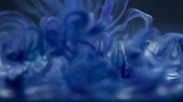 Mesmerizing blue ink swirl and dissolve in liquid: hypnotic ripple fluid art motion