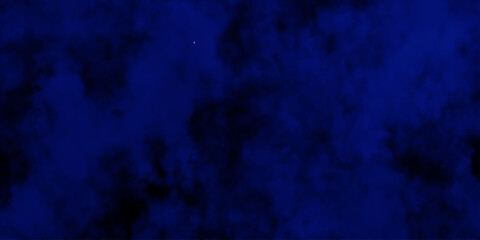 Artificial magic smoke in black and blue light on black background in darkness. light blue and dark blue background. Black and blue Grunge Concrete Wall Texture Background.