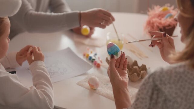 Happy Family Bonding While Painting and Decorating Colorful Easter Eggs Together