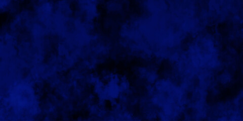 Artificial magic smoke in black and blue light on black background in darkness. light blue and dark blue background. Black and blue Grunge Concrete Wall Texture Background.