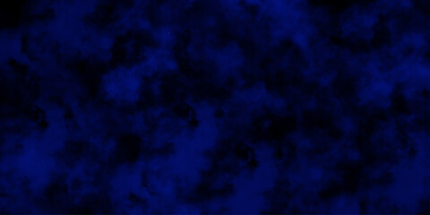 Artificial magic smoke in black and blue light on black background in darkness. light blue and dark blue background. Black and blue Grunge Concrete Wall Texture Background.