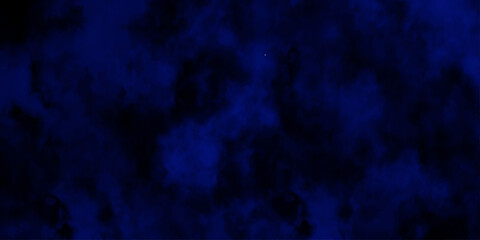 Artificial magic smoke in black and blue light on black background in darkness. light blue and dark blue background. Black and blue Grunge Concrete Wall Texture Background.