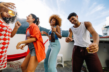 Friends enjoying a rooftop party celebrating together in summer