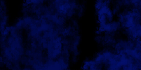 Artificial magic smoke in black and blue light on black background in darkness. light blue and dark blue background. Black and blue Grunge Concrete Wall Texture Background.