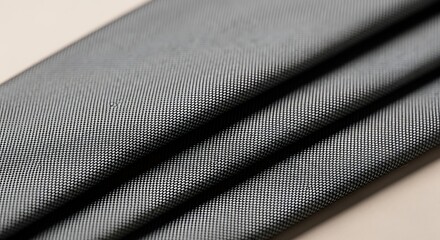 Fototapeta premium Abstract Grey Textile Background: Close-up of Folded Fabric with Diagonal Ribbed Pattern and Soft Shadows