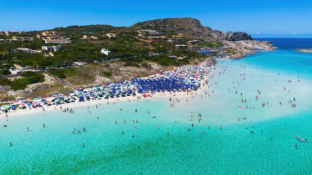 Aerial view of the crowded paradise beach La Pelosa in Stintino, Sardinia, Italy