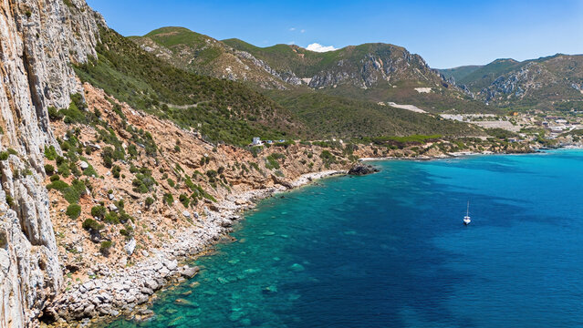Aerial view of the rugged Mediterranean coastline and turquoise waters and Masua cliffs near Porto Flavia in Sardinia