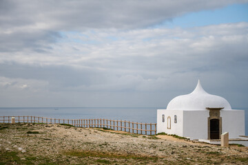 White chapel beside fenced path at Cabo Espichel