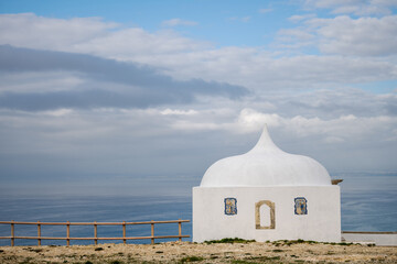 White chapel against ocean horizon at Cabo Espichel