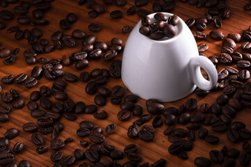 Upside down white cup with coffee bean