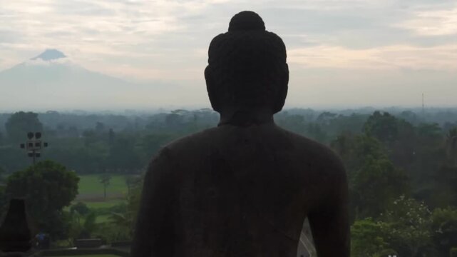 Buddha Statue Silhouette Back View Overlooking Landscape - Borobudur Temple Buddhist Meditation Spiritual Religious Sunrise Background Travel Tourism Indonesia Asia Cultural Heritage