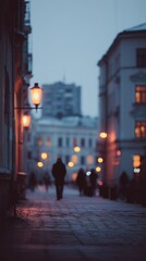 Obraz premium A moody, dimly-lit city street captures blurred figures walking under glowing streetlights in a serene urban evening.