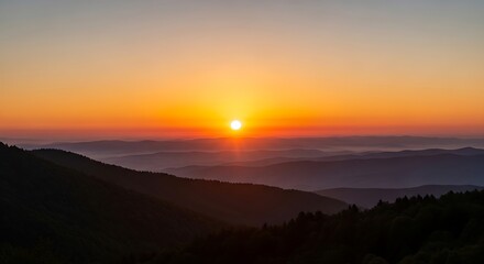 Obraz premium Breathtaking mountain sunset with layered hills and vibrant sky
