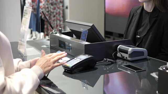 Contactless payment by smartphone at checkout payment process shows modern retail lifestyle Young customer making payment secure payment technology improves shopping convenience store evening scene