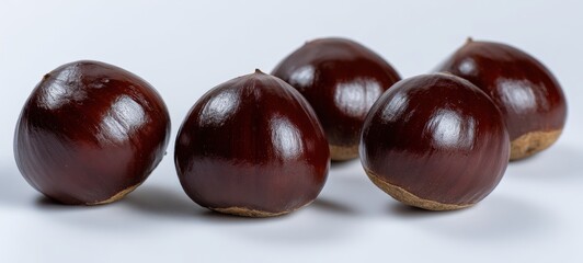 The chestnuts arranged in glossy cluster on white background with studio lighting