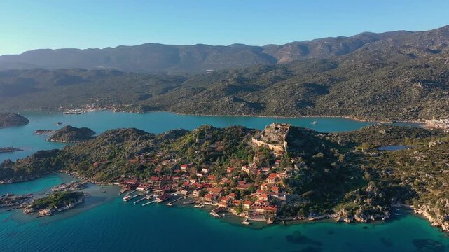 Aerial view of Byzantine fortress atop Kalek&ouml;y hill, overlooking the coastal ruins of ancient Simena near Kekova, set against the scenic backdrop of southern Turkey.