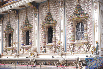 The contemporary stucco artwork in the Ordination Hall of Wat Pariwat Ratchasongkhram blends concepts related to beliefs and philosophy. Located at Bangkok city in Thailand.
