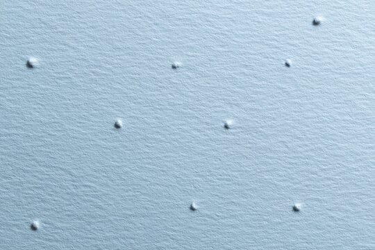 Pastel blue textured paper background with punched perforation details, luxury minimalist design