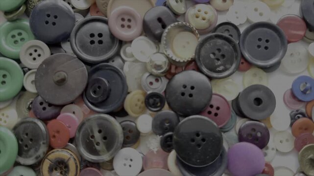Buttons background abstract slow motion pattern of dress making and haberdashery England UK 4K