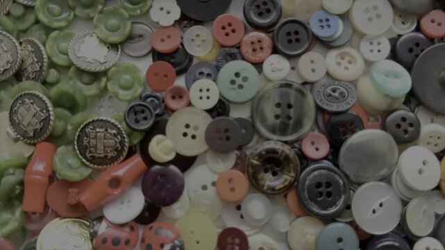 Buttons background abstract slow motion pattern of dress making and haberdashery England UK 4K