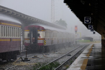 train in motion and rain in station