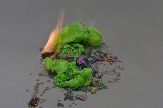 elevated view of burnt plastic bags on a gray background