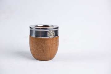 Mate cup with metal rim and metal straw isolated on white background. Traditional South American drink container, minimal product photography with copy space.