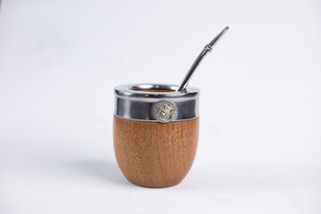 Mate cup with metal rim and metal straw isolated on white background. Traditional South American drink container, minimal product photography with copy space.