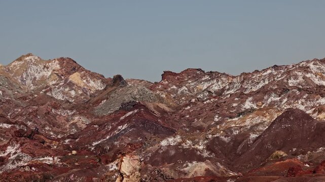 Colorful salt mountains on Hormuz Island in Iran, known as the Rainbow Island, featuring surreal mineral Martian landscape and vivid natural patterns in Persian Gulf. Unique geological formations 