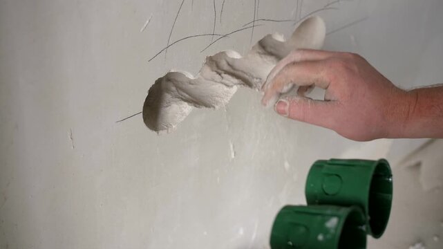 Electrician Installing Wall Socket Boxes During Interior Renovation