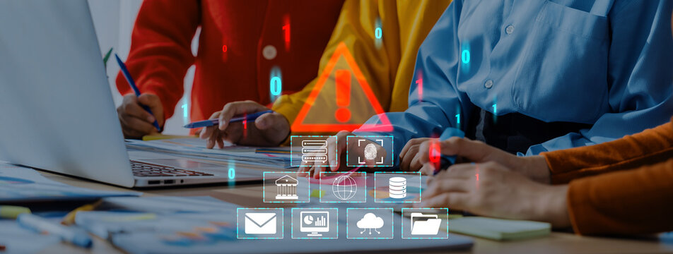 Team of Professionals Analyzing Digital Data on Laptop in Office Environment with Warning Icons and Visual Alerts Indicating Cybersecurity Concerns and Risks Quark.