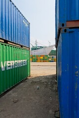 Fototapeta premium Jakarta Indonesia - 20 July 2025 - Stacked sea containers in the old harbor Sunda Kelapa with wooden cargo ships in Jakarta Indonesia