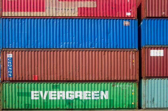 Jakarta Indonesia - 20 July 2025 - Stacked sea containers in the old harbor Sunda Kelapa with wooden cargo ships in Jakarta Indonesia