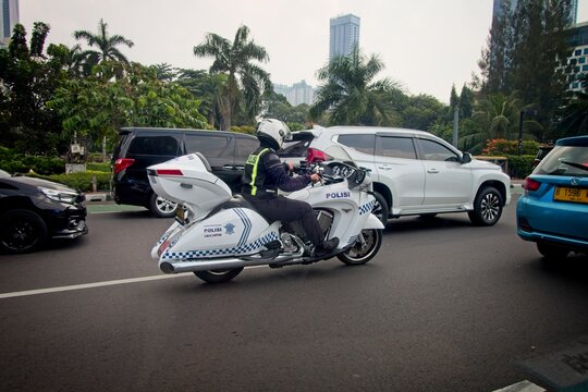 Jakarta Indonesia - 20 July 2025 - Police officer on a motorbike in Jakarta Indonesia