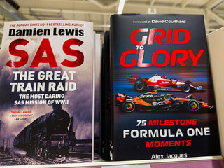 Obraz premium Two history and racing books on a shelf feature SAS mission and Formula One moments