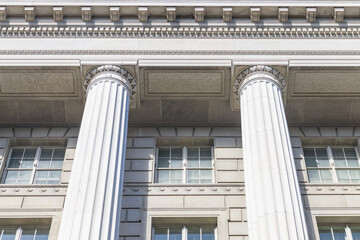 Fototapeta premium Monumental Neoclassical Architecture With Stone Columns Reliefs And Cloudless Blue Sky