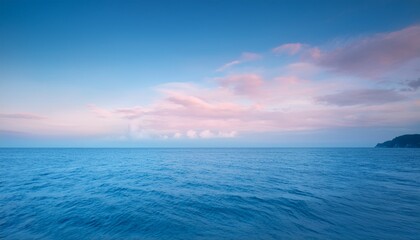 Obraz premium Calm Sea With Gentle Pink And Blue Hues Soft Pastel Sky Background