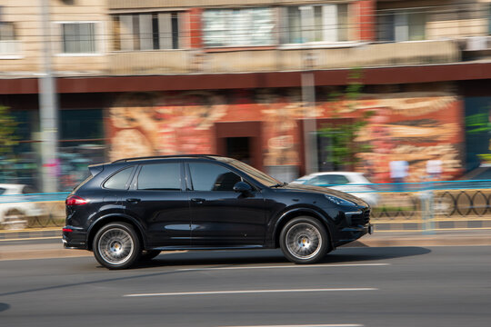 Ukraine, Kyiv - 16 Jule 2021: Black Porsche Cayenne car moving on the street. Editorial